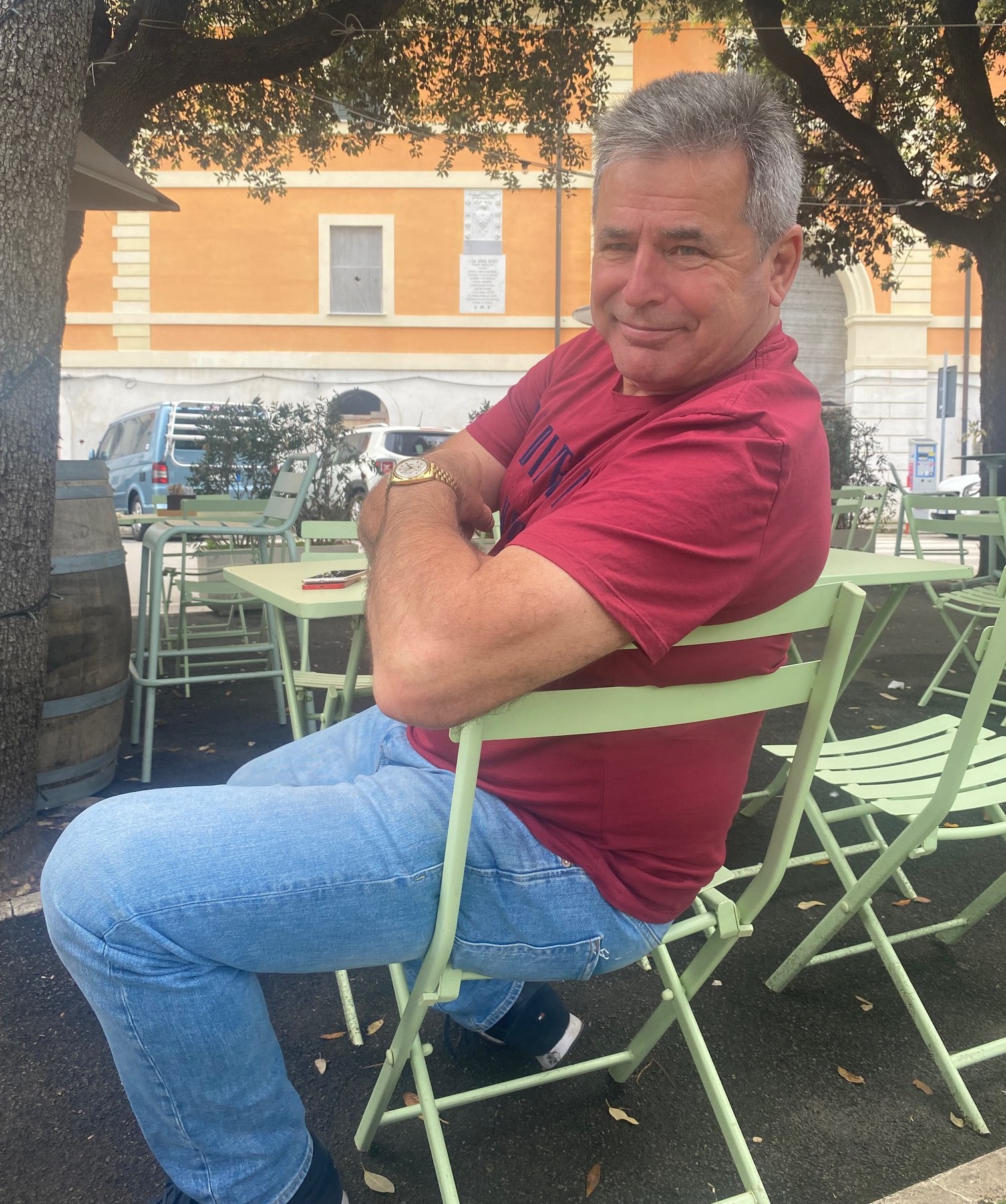 Man sitting at an outdoor cafe.