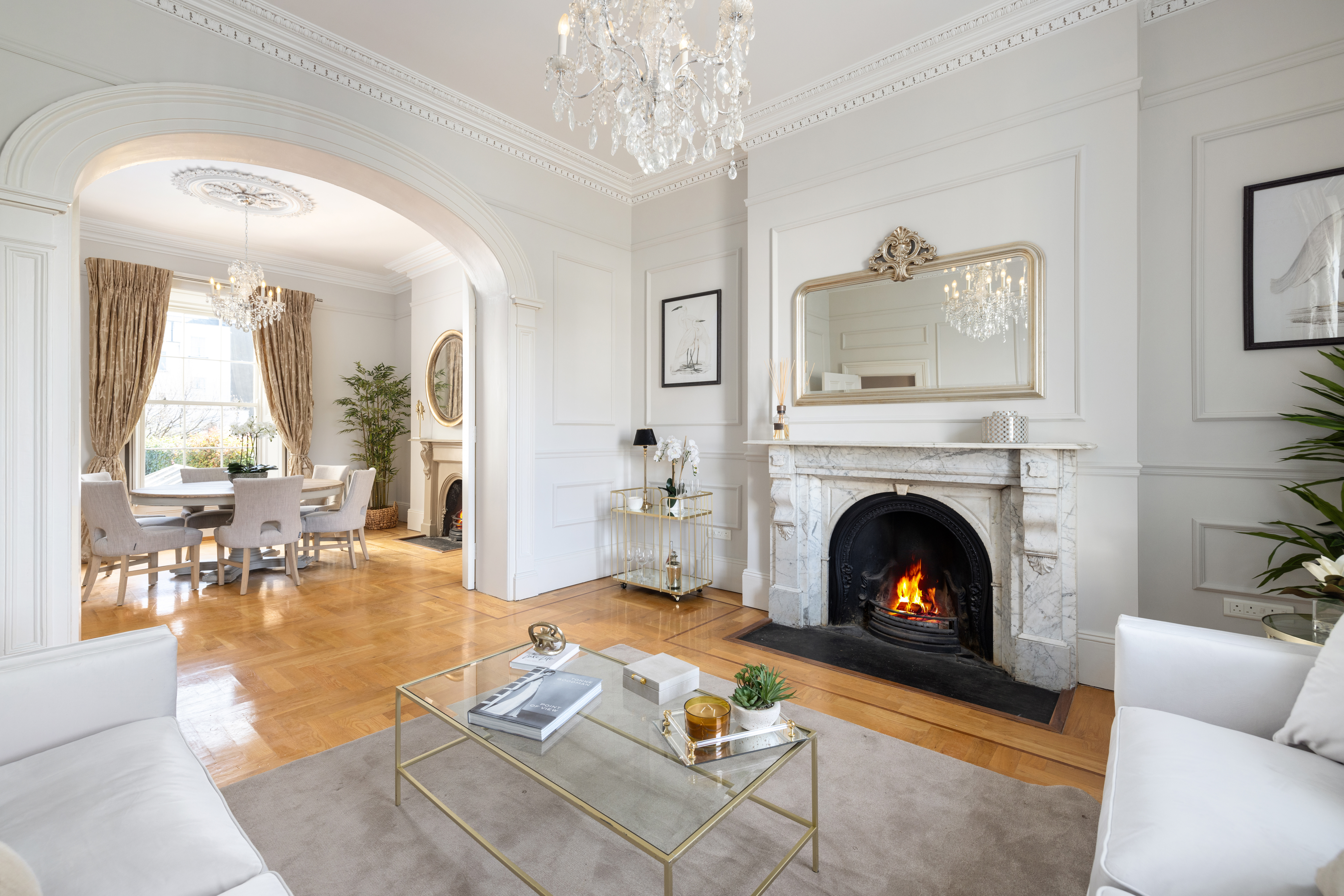 Elegant living room with fireplace and dining room view.