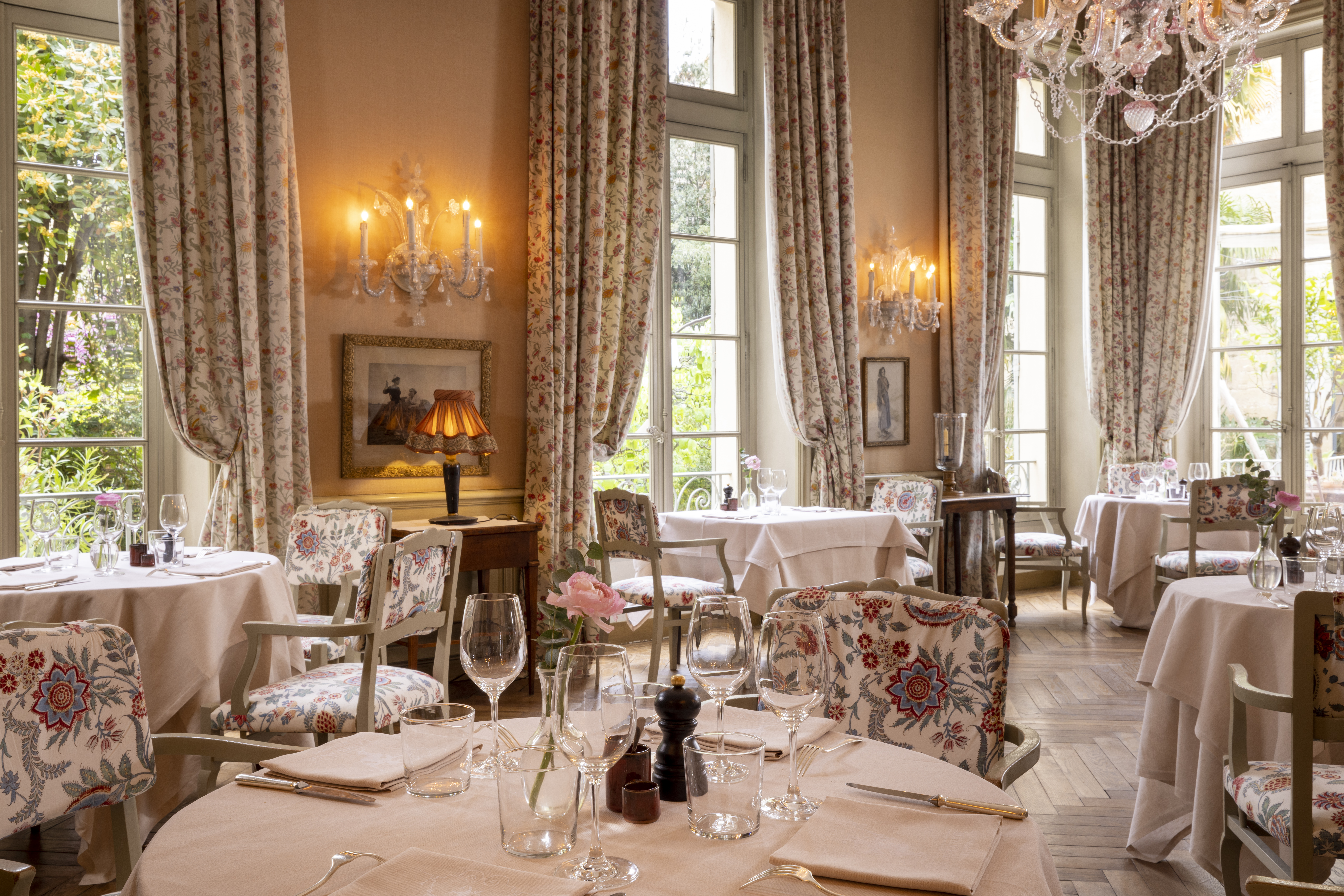 Dining room at La Mirande with tables set for meals.