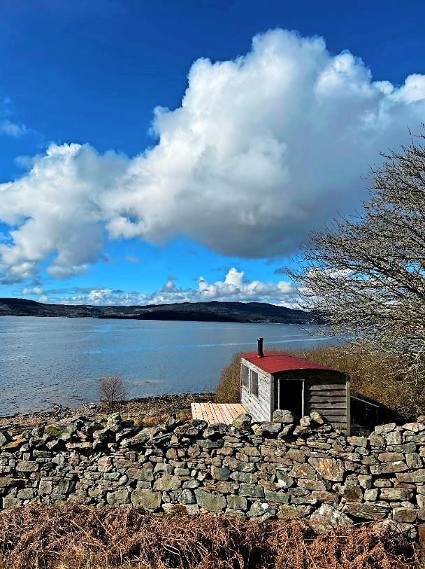 Coastal sauna overlooking a body of water.
