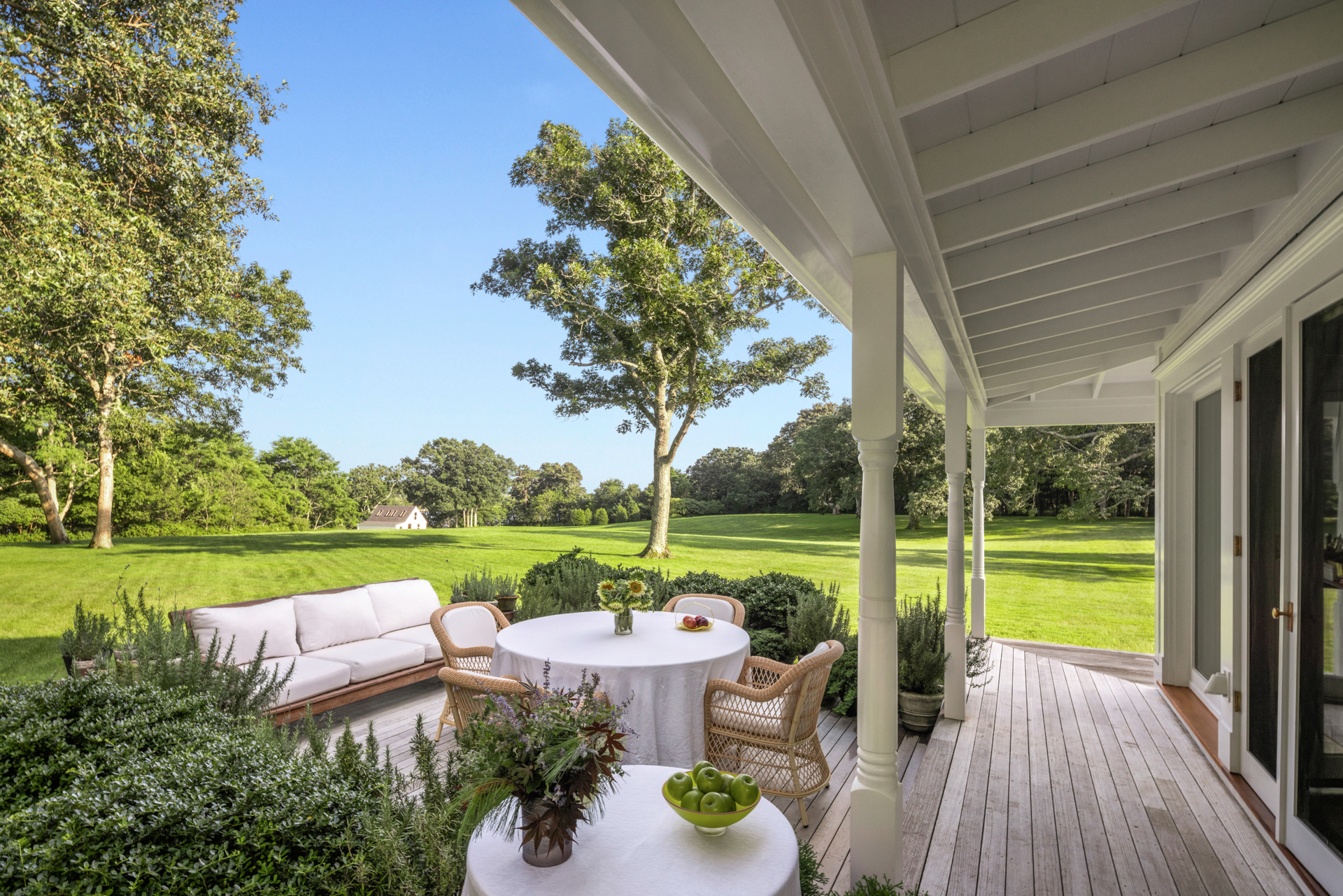Porch view of the estate overlooking a lush lawn.