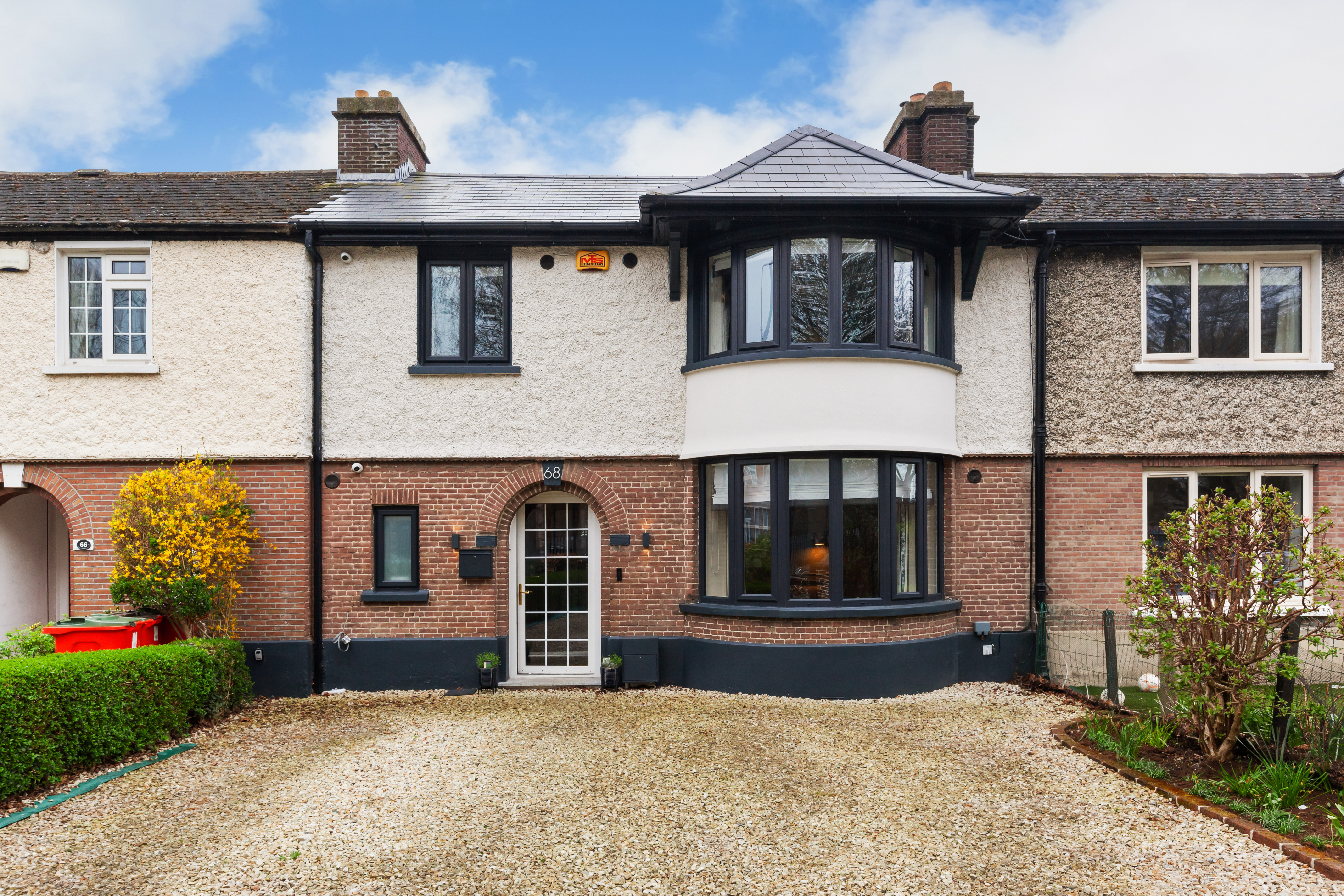A renovated terraced house with a bay window.