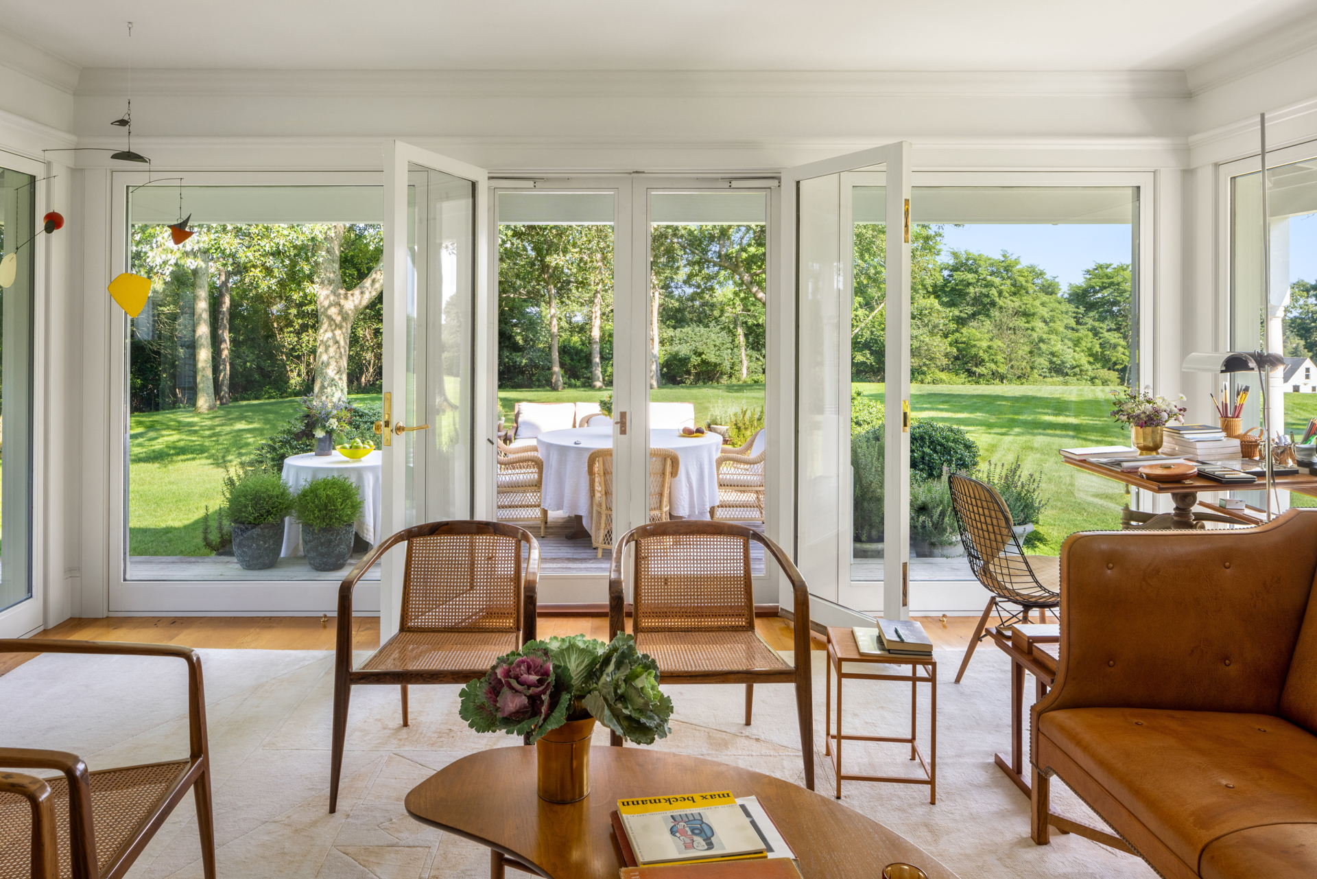 Sunroom with backyard access and rattan chairs for relaxation.