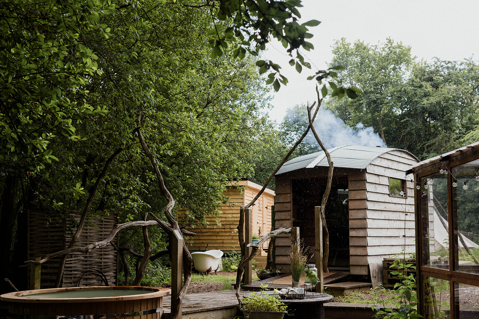 Outdoor sauna and hot tub at a woodland spa.
