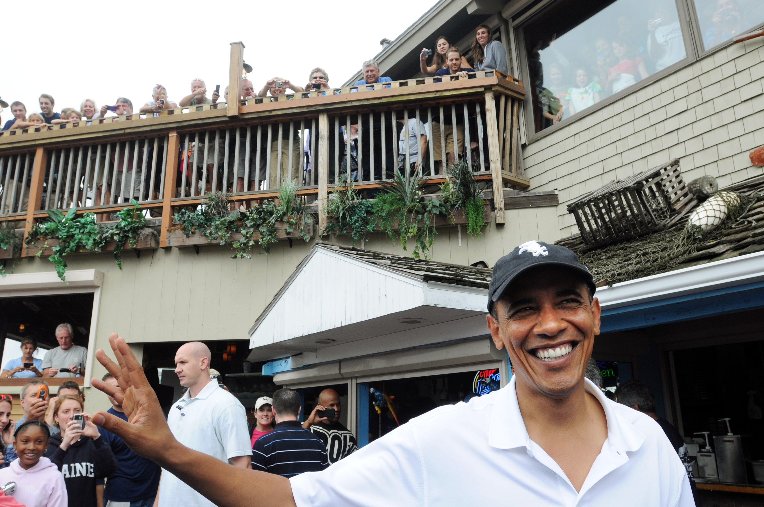 Barack Obama enjoying his vacation in Martha's Vineyard with onlookers present.